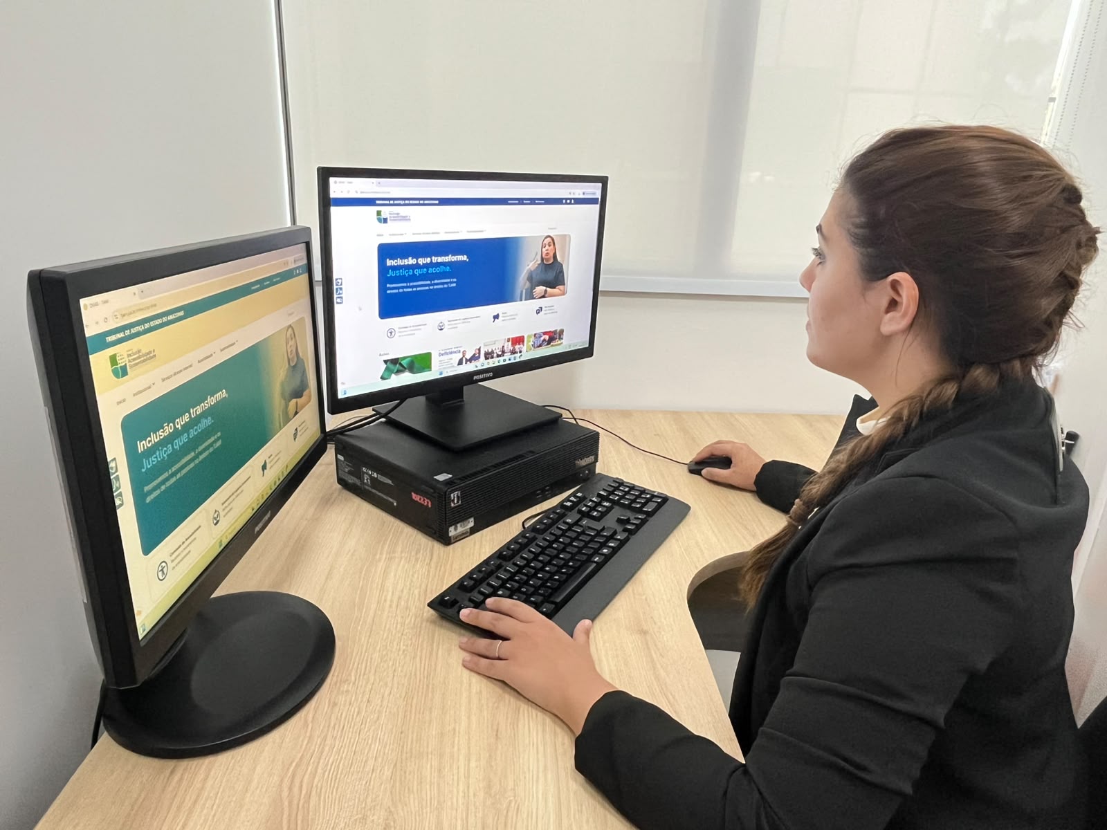 Foto mostra servidora acessando o novo site, em ambiente de trabalho.